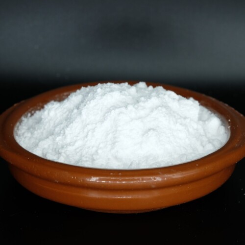 1-2 Taste VegiSURGE Natural Caffeine (Green Coffee Bean) powder in a wooden bowl